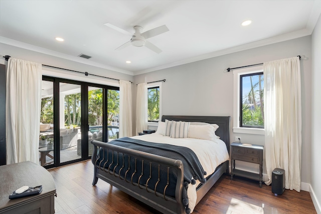 bedroom featuring multiple windows, dark wood-type flooring, and access to outside