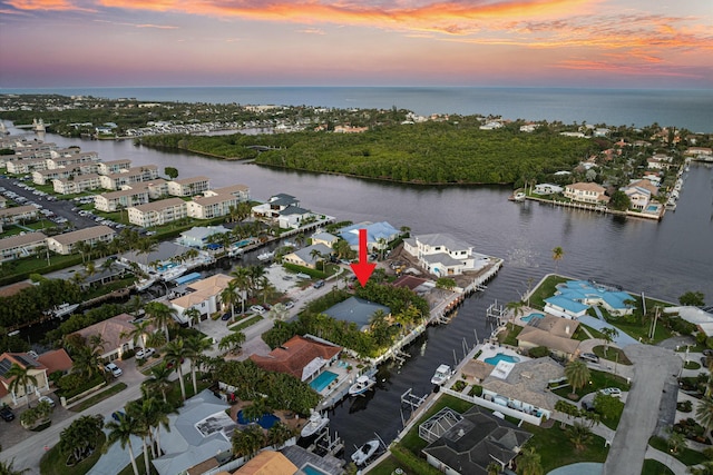 drone / aerial view with a water view and a residential view