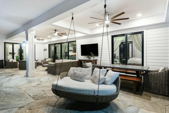 view of patio featuring a ceiling fan, an outdoor living space, and outdoor dining space