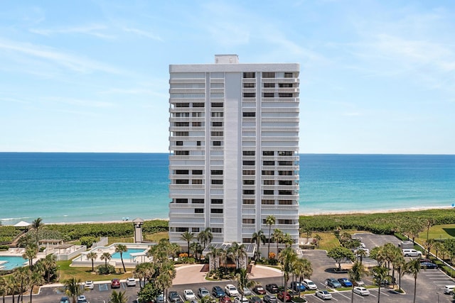 view of building exterior with a view of the beach and a water view