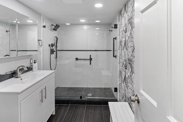 bathroom with vanity and a shower with shower door