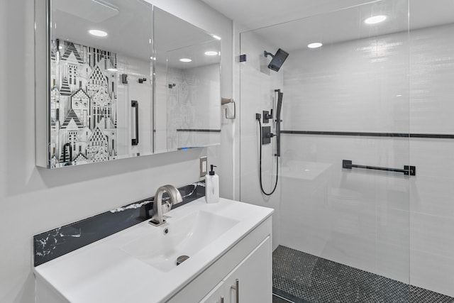 bathroom featuring vanity and tiled shower