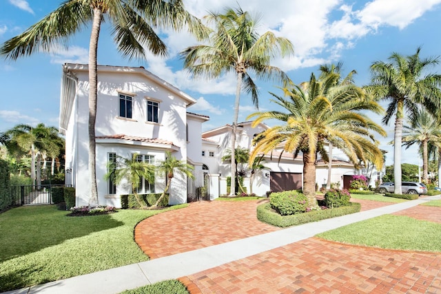 mediterranean / spanish-style house featuring a front yard