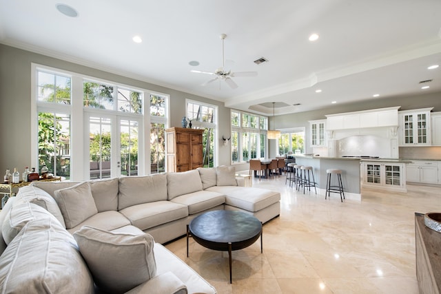 living room featuring ceiling fan, crown molding, and french doors