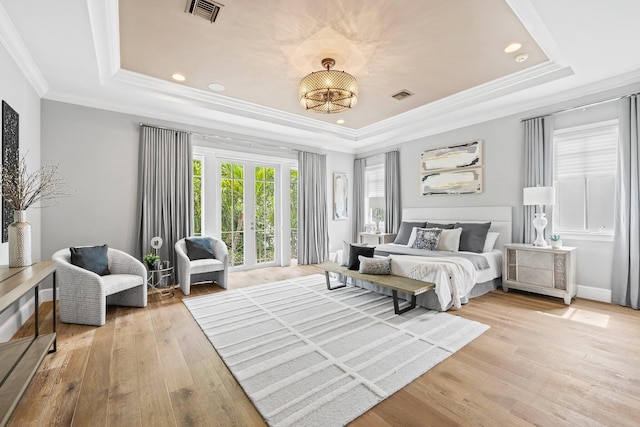 475 NE 4th St, Boca Raton, FL 33432 - bedroom with a raised ceiling, crown molding, light wood-style flooring, recessed lighting, and french doors