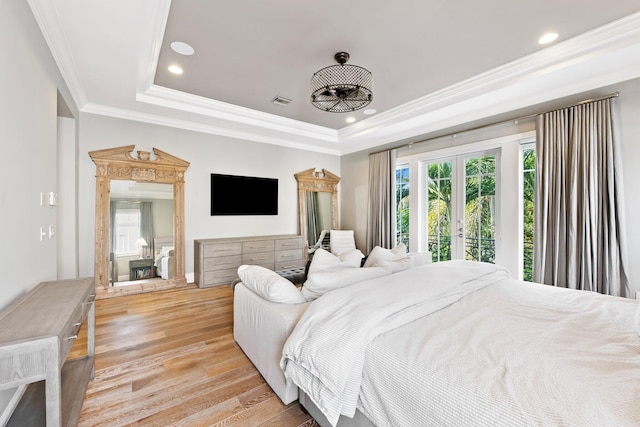 475 NE 4th St, Boca Raton, FL 33432 - bedroom with a raised ceiling, multiple windows, french doors, and light wood finished floors