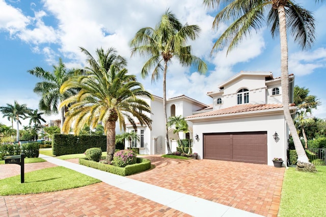 mediterranean / spanish house featuring a garage