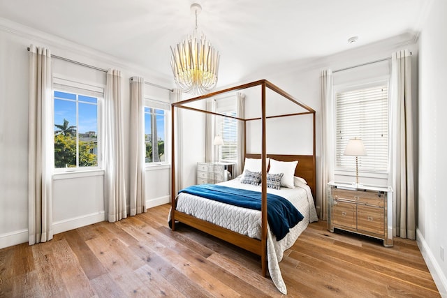 475 NE 4th St, Boca Raton, FL 33432 - bedroom with an inviting chandelier, crown molding, baseboards, and light wood finished floors