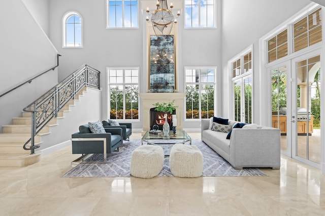 475 NE 4th St, Boca Raton, FL 33432 - living room with a towering ceiling, healthy amount of natural light, a chandelier, stairway, and a large fireplace