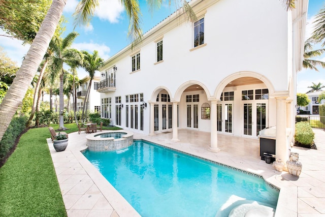475 NE 4th St, Boca Raton, FL 33432 - back of property with french doors, stucco siding, a patio area, and a balcony