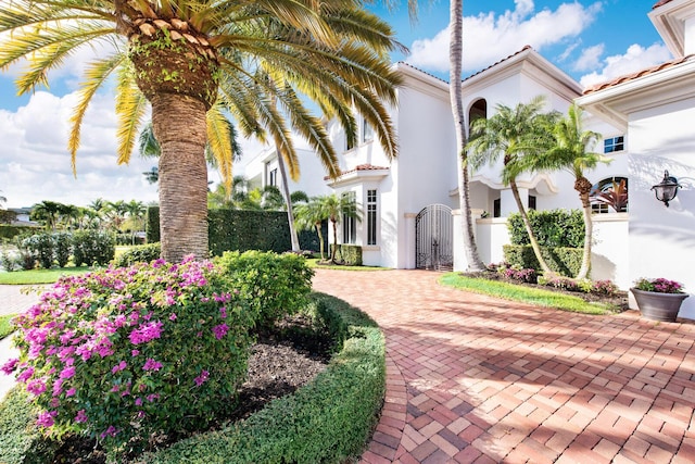 475 NE 4th St, Boca Raton, FL 33432 - view of front of home with a tiled roof, a gate, a fenced front yard, and stucco siding