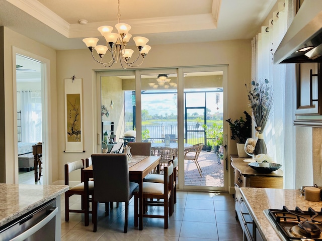 9597 SW Royal Poinciana Dr, Port Saint Lucie, FL 34987 - dining space with crown molding, a tray ceiling, an inviting chandelier, and light tile patterned floors