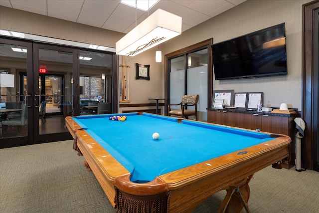 9597 SW Royal Poinciana Dr, Port Saint Lucie, FL 34987 - recreation room with a drop ceiling, carpet floors, and french doors
