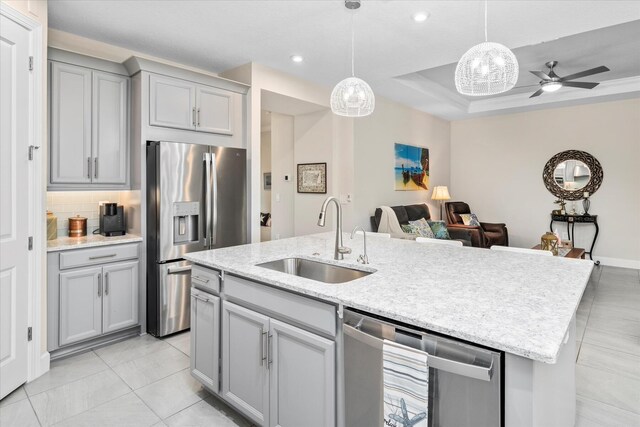 9597 SW Royal Poinciana Dr, Port Saint Lucie, FL 34987 - kitchen with stainless steel appliances, an island with sink, sink, and pendant lighting