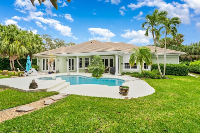 back of house with a yard, a patio area, and french doors