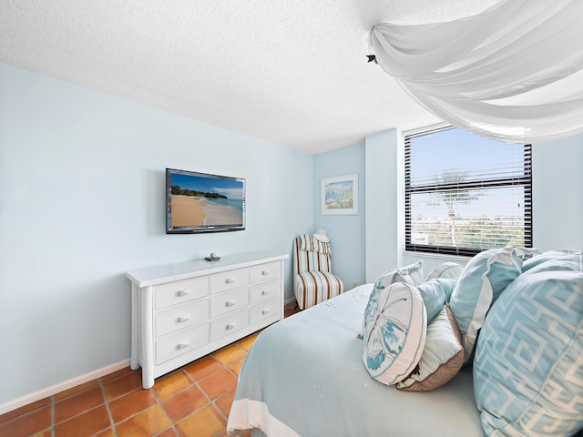 bedroom with light tile patterned floors and a textured ceiling