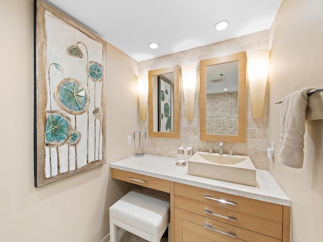 bathroom featuring vanity and decorative backsplash