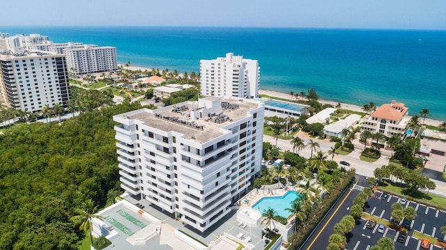 birds eye view of property featuring a beach view and a water view