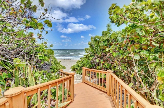 wooden terrace with a water view and a beach view