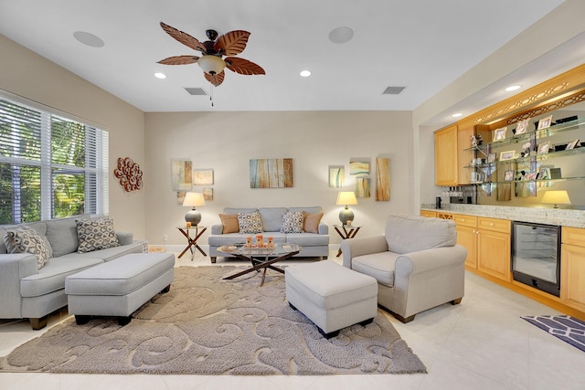 living room featuring light tile patterned flooring, bar, wine cooler, and ceiling fan