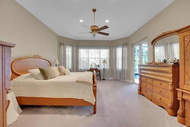 bedroom featuring multiple windows, access to outside, light colored carpet, and ceiling fan