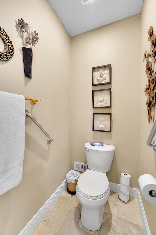 bathroom with tile patterned flooring and toilet