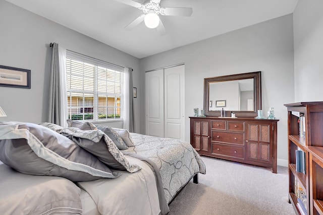 carpeted bedroom featuring ceiling fan and a closet