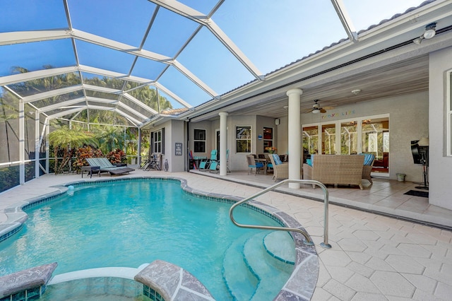 view of pool with ceiling fan, a patio, an outdoor hangout area, and glass enclosure