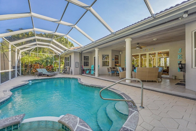 view of swimming pool with ceiling fan, an outdoor hangout area, a patio area, and glass enclosure