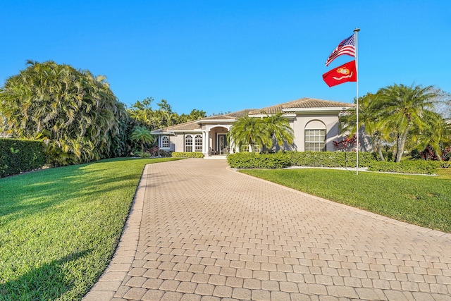 view of front of home with a front yard and french doors