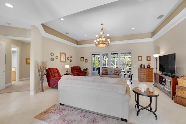 tiled living room featuring a raised ceiling and a notable chandelier