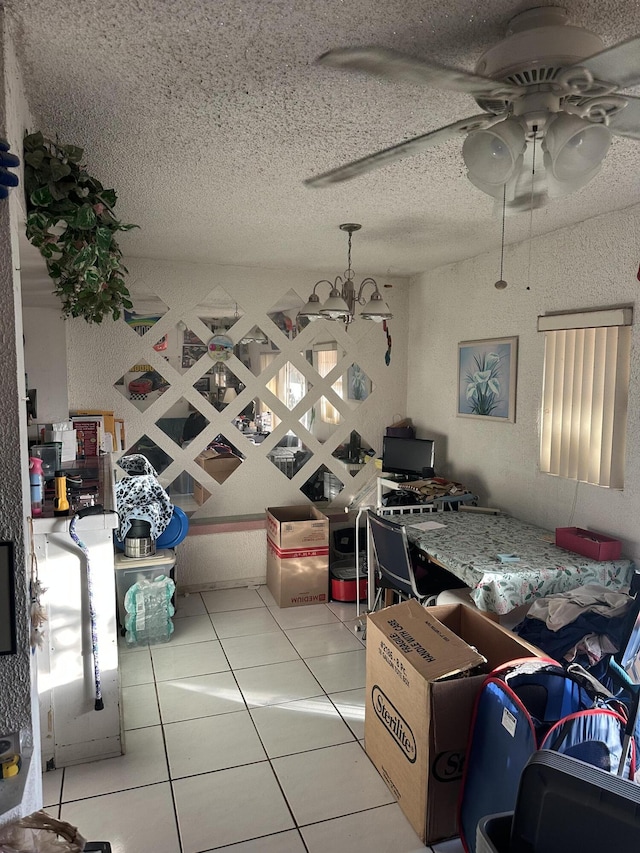 interior space featuring a ceiling fan, a textured ceiling, and tile patterned floors