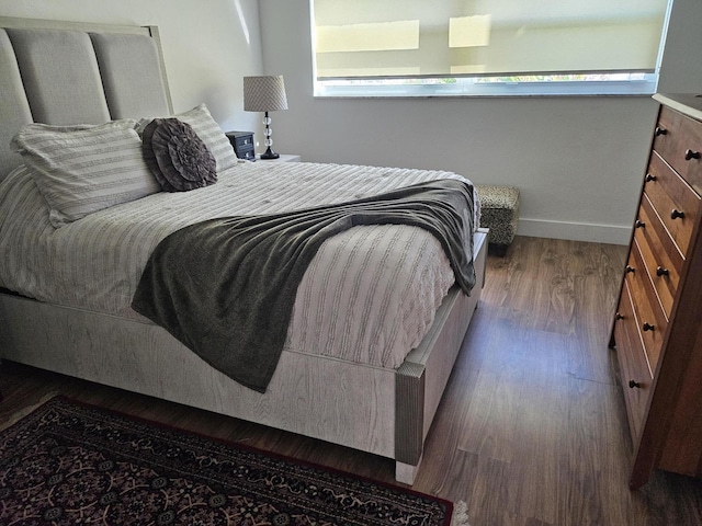 bedroom featuring dark hardwood / wood-style flooring