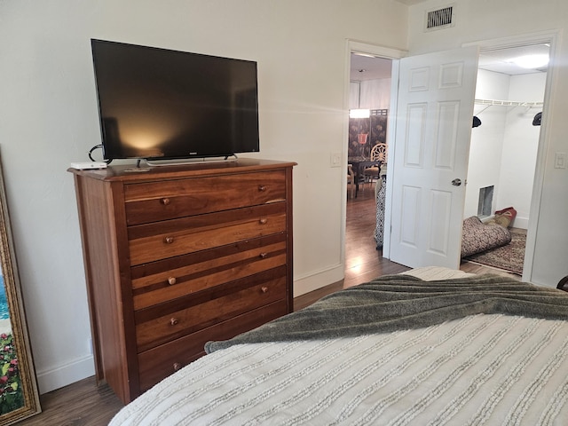 bedroom with dark hardwood / wood-style floors