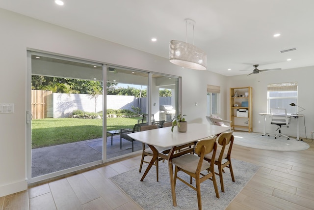 dining space featuring recessed lighting, light wood-type flooring, a healthy amount of sunlight, and visible vents