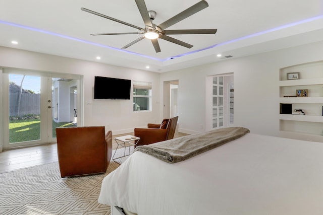 bedroom featuring recessed lighting, baseboards, a raised ceiling, and ceiling fan