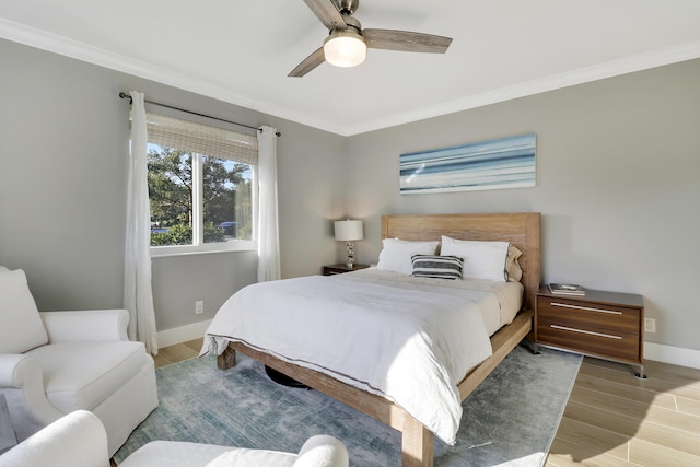 bedroom featuring wood finished floors, baseboards, and ornamental molding