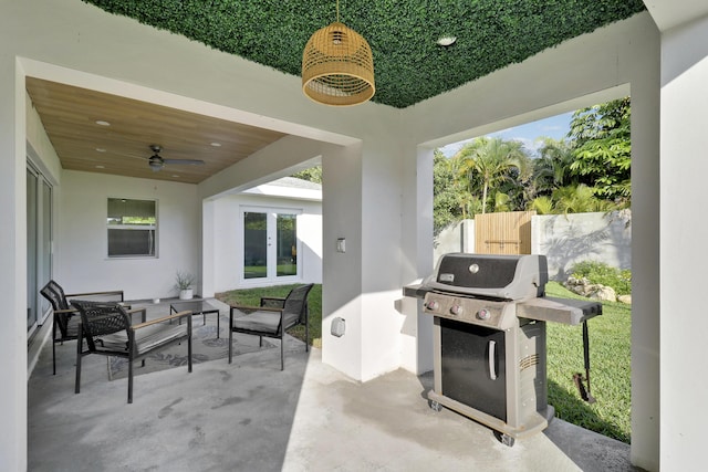 view of patio featuring ceiling fan, french doors, fence, and grilling area