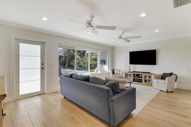 living room with visible vents, light wood-style flooring, recessed lighting, ceiling fan, and crown molding