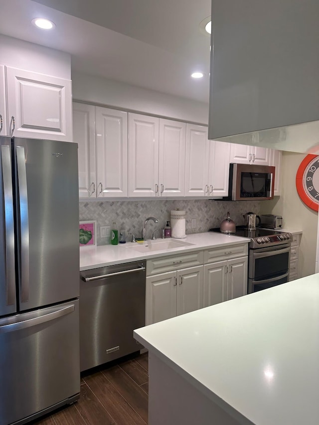 kitchen with white cabinetry, sink, and stainless steel appliances