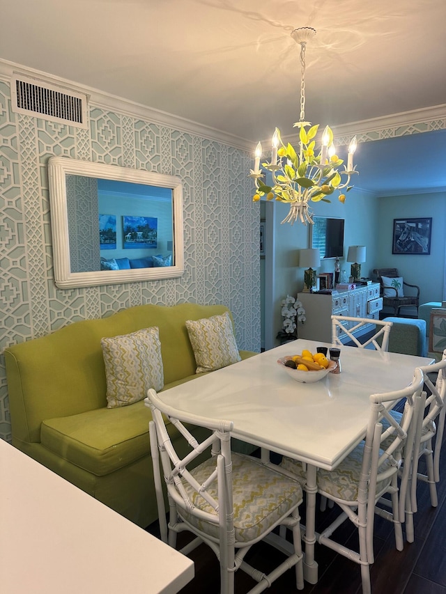 dining room featuring crown molding and an inviting chandelier