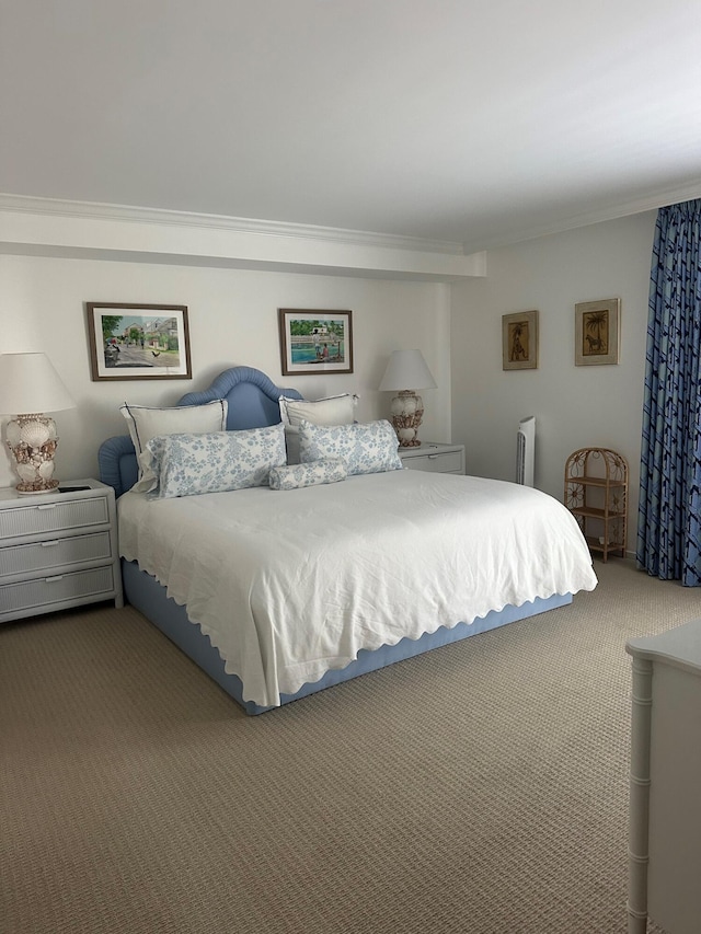 bedroom with crown molding and carpet