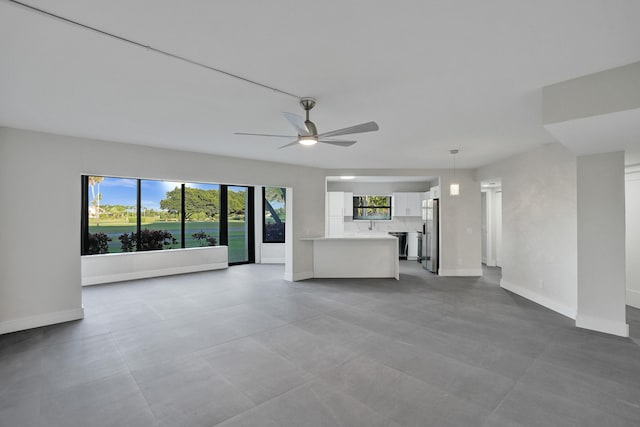 unfurnished living room with ceiling fan