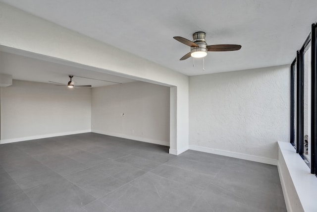 interior space with ceiling fan