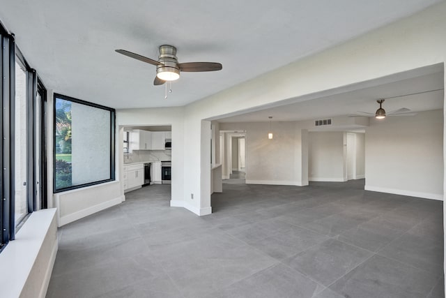 unfurnished living room with ceiling fan