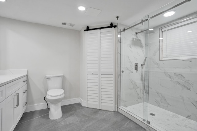 bathroom with vanity, toilet, and a shower with shower door