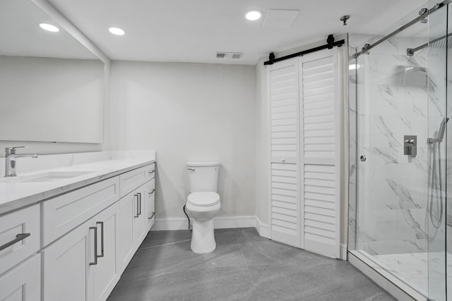 bathroom featuring a shower with door, vanity, and toilet