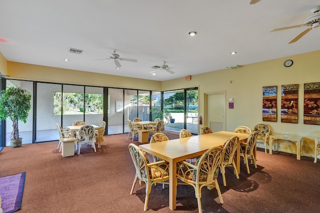 carpeted dining room featuring ceiling fan