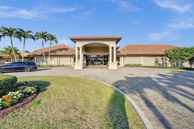 mediterranean / spanish-style house featuring a front lawn