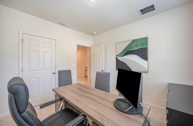 bedroom with light carpet and connected bathroom